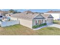 One-story house with light beige siding, brown shutters, and a two-car garage at 2936 Ne 43Rd Rd, Ocala, FL 34470