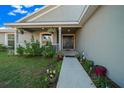 Covered front porch with walkway, potted plants, and a charming entrance at 38 Spring Trce, Ocala, FL 34472