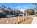 Home with detached garage and white vinyl fence at 3899 Se 80Th St, Ocala, FL 34480