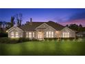 Beautiful single-Gathering home featuring stone accents, manicured lawn, and mature landscaping at dusk at 4020 Se 9Th Ave, Ocala, FL 34480