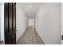 A bright hallway features white walls, light wood flooring, and leads to a spacious living area at 5200 Nw 54Th Pl, Ocala, FL 34482