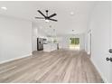 Expansive living area featuring light wood floors, recessed lighting, and an open view to the kitchen at 55 Locust Loop Cir, Ocala, FL 34472