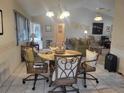 Cozy dining area with a round table and four chairs, overlooking the living room at 5555 Sw 107Th St, Ocala, FL 34476