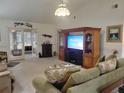 Bright living room featuring comfy seating and a large entertainment center at 5555 Sw 107Th St, Ocala, FL 34476