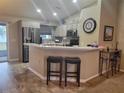 Modern kitchen with stainless steel appliances and breakfast bar at 8187 Sw 60Th Ter, Ocala, FL 34476