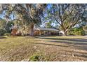 Ranch style home on a spacious lot with large oak trees at 820 Ne 42Nd Ter, Ocala, FL 34470