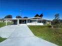 Inviting single-story home featuring covered parking and a screened in entry for outdoor enjoyment at 8973 Sw 101St Ln, Ocala, FL 34481