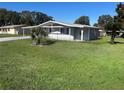 Well-maintained single-story home with a large front yard and mature landscaping on a sunny day at 8973 Sw 101St Ln, Ocala, FL 34481