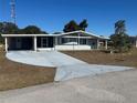 Front view of a single story home with a carport at 8973 Sw 101St Ln, Ocala, FL 34481