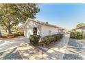 Side view of home showcasing walkway and landscaping at 9267 Sw 91St Cir, Ocala, FL 34481