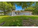 House with light blue exterior and lush green lawn at 10557 Sw 62Nd Ct, Ocala, FL 34476