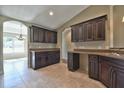 Spacious kitchen featuring dark wood cabinets and granite countertops at 14269 Se 27Th Ct, Summerfield, FL 34491