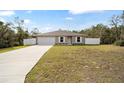 Newly built home with a fenced yard and a concrete driveway at 16050 Sw 35Th Court Rd, Ocala, FL 34473