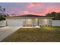 House exterior at sunset with landscaped yard at 16050 Sw 35Th Court Rd, Ocala, FL 34473