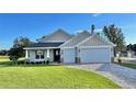 Newly constructed home with two-car garage and manicured lawn at 17920 Sw 66Th Pl, Dunnellon, FL 34432