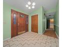 Bright entryway with tiled floors, wood door, and built-in storage at 1981 Se 54Th Ter, Ocala, FL 34480