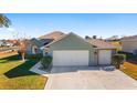 House exterior with two-car garage and a nicely landscaped yard at 2111 Nw 58Th Ct, Ocala, FL 34482