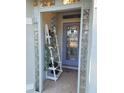 Inviting entryway with a white ladder and blue door at 2969 Sw 142Nd Ln, Ocala, FL 34473