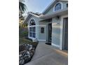 Light teal house with a walkway leading to the front door at 2969 Sw 142Nd Ln, Ocala, FL 34473