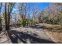 Paved walking path alongside a tranquil waterway, shaded by trees at 4925 Cr 309B, Lake Panasoffkee, FL 33538