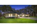 Evening view of house exterior with well-manicured lawn at 5224 Se 44Th Cir, Ocala, FL 34480