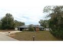 Traditional single story home with neutral colors and a front lawn at 5491 Sw 100Th Loop, Ocala, FL 34476