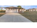 Exterior view of a house with a long driveway at 5525 Sw 80Th Pl, Ocala, FL 34476