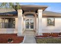 Front entrance with double doors and decorative columns at 5525 Sw 80Th Pl, Ocala, FL 34476