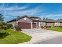 Two-story home with three-car garage and well-manicured lawn at 6758 Sw 94Th Cir, Ocala, FL 34481