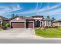 Two-story home with three-car garage and beautiful landscaping at 6758 Sw 94Th Cir, Ocala, FL 34481