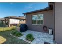 Brick paved patio with grill and lush landscaping at 6758 Sw 94Th Cir, Ocala, FL 34481