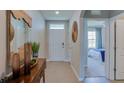 Bright entryway with wood console table and view to bedroom at 8489 Las Palmas Way, Wildwood, FL 34785