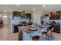 Modern kitchen with stainless steel appliances and granite countertops at 8489 Las Palmas Way, Wildwood, FL 34785