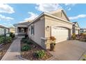 Well-maintained house with a two-car garage and landscaped walkway at 9872 Sw 99Th Loop, Ocala, FL 34481