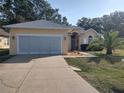 Tan house with attached two-car garage and palm tree at 11105 Sw 69Th Cir, Ocala, FL 34476