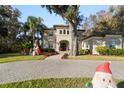 Two-story house with a paver driveway and Christmas decorations at 1219 Se 46Th St, Ocala, FL 34480