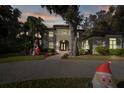 Two-story house with lighting and Christmas decorations in the front yard at 1219 Se 46Th St, Ocala, FL 34480