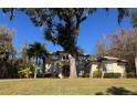 Two-story house with a tile roof, manicured lawn, and mature trees at 1219 Se 46Th St, Ocala, FL 34480