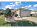 House exterior featuring a walkway and landscaping at 12498 Se 92Nd Ave, Summerfield, FL 34491