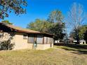 Charming home with a screened sunroom and spacious backyard at 15000 Sw 27Th Ln, Ocala, FL 34481