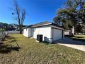 The home's garage, featuring a white exterior and a neatly landscaped yard at 1846 Ne 127Th Pl, Anthony, FL 32617