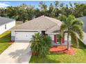 Attractive one-story house with a palm tree and well-maintained lawn at 2457 Bulrush Dr, Saint Cloud, FL 34769