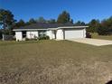 One-story house with attached garage and grassy yard at 2520 Sw 143 Ave, Ocala, FL 34481