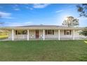 Ranch-style home with covered porch at 3996 Se 150Th St, Summerfield, FL 34491