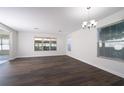 Bright dining room with dark wood floors and a chandelier at 4098 Sw 51 St, Ocala, FL 34474