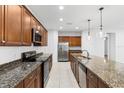 Modern kitchen with granite countertops and stainless steel appliances at 4314 Sw 65Th Pl, Ocala, FL 34474