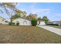 Single story home with a long driveway and landscaping at 4377 Ne 13Th St, Ocala, FL 34470