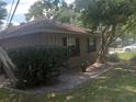 Side view of the house with green landscaping at 4434 Se 10Th Pl, Ocala, FL 34471