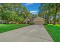 House exterior with a long driveway and a nicely landscaped yard at 4977 Se 44Th Cir, Ocala, FL 34480