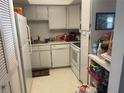 Small kitchen with white cabinets and appliances at 533 Midway Dr # B, Ocala, FL 34472